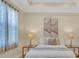 Bright bedroom with neutral colors, stylish lamps, and soft, inviting linens at 635 Chipper Dr, Sun City Center, FL 33573