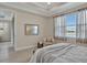 Tranquil bedroom with large window and serene view of the garden and water at 635 Chipper Dr, Sun City Center, FL 33573