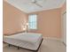 Cozy bedroom with a ceiling fan, neutral walls and tile flooring creates a comfortable and inviting space at 635 Chipper Dr, Sun City Center, FL 33573