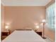 Inviting bedroom features a simple bed frame, side tables with lamps, and soft, neutral wall color at 635 Chipper Dr, Sun City Center, FL 33573
