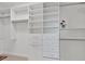 Bright closet features custom white shelving, drawers, and hanging space for optimal organization at 635 Chipper Dr, Sun City Center, FL 33573