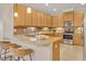 Well-lit kitchen featuring wood cabinets, granite countertops, and stainless steel appliances at 635 Chipper Dr, Sun City Center, FL 33573