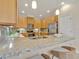 Bright kitchen with granite countertops, stainless steel appliances, and barstool seating at 635 Chipper Dr, Sun City Center, FL 33573