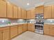 Kitchen with stainless steel appliances, wooden cabinets, and tile backsplash over granite countertops at 635 Chipper Dr, Sun City Center, FL 33573