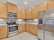 Well-equipped kitchen with stainless steel appliances and ample counter space for cooking at 635 Chipper Dr, Sun City Center, FL 33573