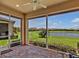 Screened-in lanai offers tranquil water views, creating an ideal outdoor relaxation and dining space at 635 Chipper Dr, Sun City Center, FL 33573