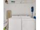 A well-equipped laundry room features a washer, dryer, and ample shelving for storage at 635 Chipper Dr, Sun City Center, FL 33573