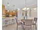 Open concept kitchen and living area with bar seating, dining table, and stainless steel appliances at 635 Chipper Dr, Sun City Center, FL 33573
