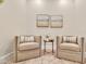 Comfortable living room with neutral armchairs, soft rug, and tranquil artwork creating a relaxing ambiance at 635 Chipper Dr, Sun City Center, FL 33573