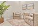 Comfortable living room with neutral armchairs, soft rug, and tranquil artwork creating a relaxing ambiance at 635 Chipper Dr, Sun City Center, FL 33573
