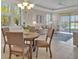 Open-concept living area with dining table, tile floors, plenty of natural light, and lake views at 635 Chipper Dr, Sun City Center, FL 33573