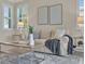 Comfortable living room featuring tile floors, plantation shutters, neutral furniture, and a modern coffee table at 635 Chipper Dr, Sun City Center, FL 33573