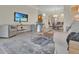 Open-concept living area with dining table, tile floors, neutral furniture, and a view of a flat screen television at 635 Chipper Dr, Sun City Center, FL 33573