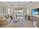 Cozy living room featuring neutral palette, a view to the lake, and comfortable seating at 635 Chipper Dr, Sun City Center, FL 33573