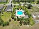 Aerial view of a community pool, surrounded by lush landscaping and offering a resort-like experience at 635 Chipper Dr, Sun City Center, FL 33573