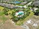 Aerial view of a community pool area with lush landscaping and ample seating, perfect for relaxing at 635 Chipper Dr, Sun City Center, FL 33573