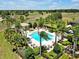 Aerial view of a community pool surrounded by lush landscaping, providing a serene and tropical escape at 635 Chipper Dr, Sun City Center, FL 33573