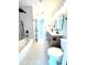 Well-lit bathroom showcasing a soaking tub, stylish fixtures, and modern wood vanity with double sinks at 6524 Senegal Palm Way, Apollo Beach, FL 33572