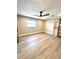 Spacious bedroom featuring a ceiling fan, plank flooring, and a sliding barn door at 6524 Senegal Palm Way, Apollo Beach, FL 33572