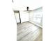 Well-lit bedroom with fan, closet, window offering natural light, and wood-look laminate flooring at 6524 Senegal Palm Way, Apollo Beach, FL 33572