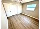 Inviting bedroom with fan, closet space, window bringing in natural light, and laminate flooring at 6524 Senegal Palm Way, Apollo Beach, FL 33572