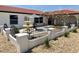 Landscaped courtyard with a three-tiered fountain, patio umbrella, and decorative black metal fencing at 6524 Senegal Palm Way, Apollo Beach, FL 33572