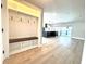 Entryway with built-in bench and storage leading into the open concept kitchen and living areas at 6524 Senegal Palm Way, Apollo Beach, FL 33572
