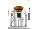 Wrought iron entry gate with keystone arch, overhead wood ceiling, and address plaque at 6524 Senegal Palm Way, Apollo Beach, FL 33572