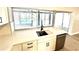 Kitchen island with modern sink, stainless steel dishwasher and beautiful views of the pool at 6524 Senegal Palm Way, Apollo Beach, FL 33572