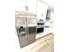 Bright kitchen features stainless steel appliances, white cabinets and light countertops at 6524 Senegal Palm Way, Apollo Beach, FL 33572