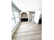 Open living space with a modern arched wall feature, built-in buffet, and light wood flooring at 6524 Senegal Palm Way, Apollo Beach, FL 33572