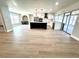 Open concept living area featuring recessed lighting, modern kitchen, and light wood flooring at 6524 Senegal Palm Way, Apollo Beach, FL 33572