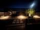 Night shot of screened-in pool area with paver pathway and accent lighting at 6524 Senegal Palm Way, Apollo Beach, FL 33572