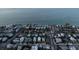 An aerial view shows the home is located near the ocean, offering a serene coastal lifestyle and neighborhood charm at 704 Gladiolus St, Anna Maria, FL 34216