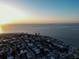 Beautiful aerial view of beachfront homes with ocean view and blue skies at sunrise at 704 Gladiolus St, Anna Maria, FL 34216