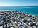 Aerial view showcases a coastal property nestled in a charming neighborhood near the ocean at 704 Gladiolus St, Anna Maria, FL 34216