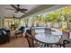 Expansive back porch area is overlooking a pool and a vibrant tropical landscape, perfect for outdoor living at 704 Gladiolus St, Anna Maria, FL 34216