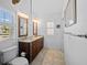 Elegant bathroom boasting a double vanity with granite countertops and ample natural light at 704 Gladiolus St, Anna Maria, FL 34216