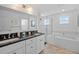 Bright bathroom with double vanity, soaking tub and glass enclosed shower at 704 Gladiolus St, Anna Maria, FL 34216