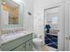 Charming bathroom with a vibrant green vanity and a view into the well-lit bedroom at 704 Gladiolus St, Anna Maria, FL 34216