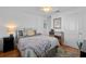 Tranquil bedroom showcasing a cozy queen bed with fan and natural light at 704 Gladiolus St, Anna Maria, FL 34216