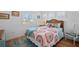 Bright bedroom featuring a cozy bed with colorful patterned bedding and accent pillows at 704 Gladiolus St, Anna Maria, FL 34216
