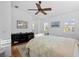 Bright bedroom with a ceiling fan, dresser, plantation shutters, and carpet at 704 Gladiolus St, Anna Maria, FL 34216