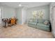 Bright bonus room offers tile flooring, a comfortable sofa, and a ceiling fan at 704 Gladiolus St, Anna Maria, FL 34216