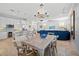 Bright dining area with a wooden table and seating next to the kitchen and living room at 704 Gladiolus St, Anna Maria, FL 34216