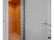 An elevator sits at the top of the stairs, behind a white wooden door, providing accessibility in the home at 704 Gladiolus St, Anna Maria, FL 34216