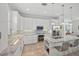 Modern kitchen featuring white cabinets, granite countertops, stainless steel appliances, and a spacious center island at 704 Gladiolus St, Anna Maria, FL 34216