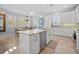 Bright kitchen with a granite island, stainless steel appliances, and a cozy dining area at 704 Gladiolus St, Anna Maria, FL 34216