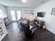 Inviting living room with dark hardwood floors, comfortable seating, and stylish decor at 704 Gladiolus St, Anna Maria, FL 34216