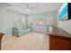 Airy living room boasts natural light, tiled floors, and a comfortable sofa, creating a relaxing space at 704 Gladiolus St, Anna Maria, FL 34216